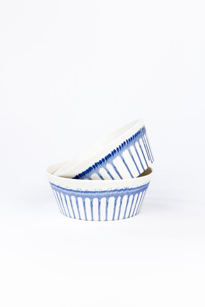 Side view of 2 MOCA handmade ceramic bowls – each with the same blue dripping pattern
