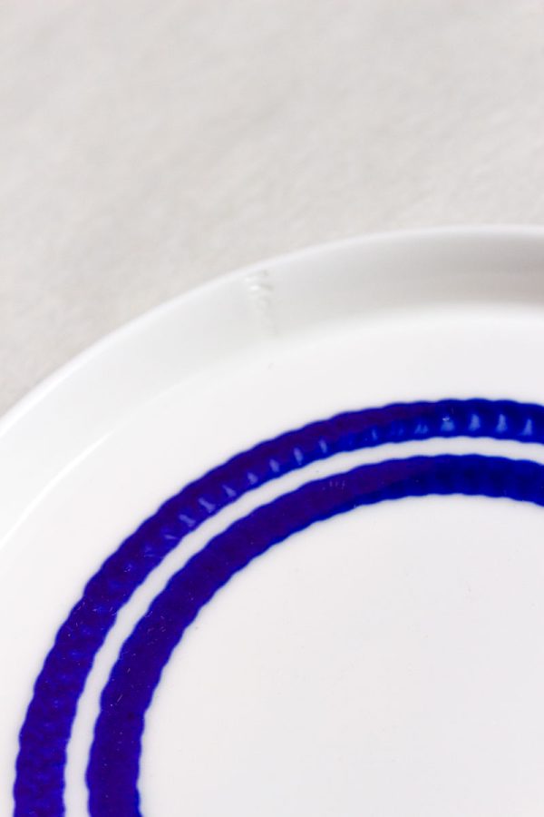 Close-up MOCA handmade ceramic dessert plate 16cm – two connected circular blue glaze lines, dripping texture